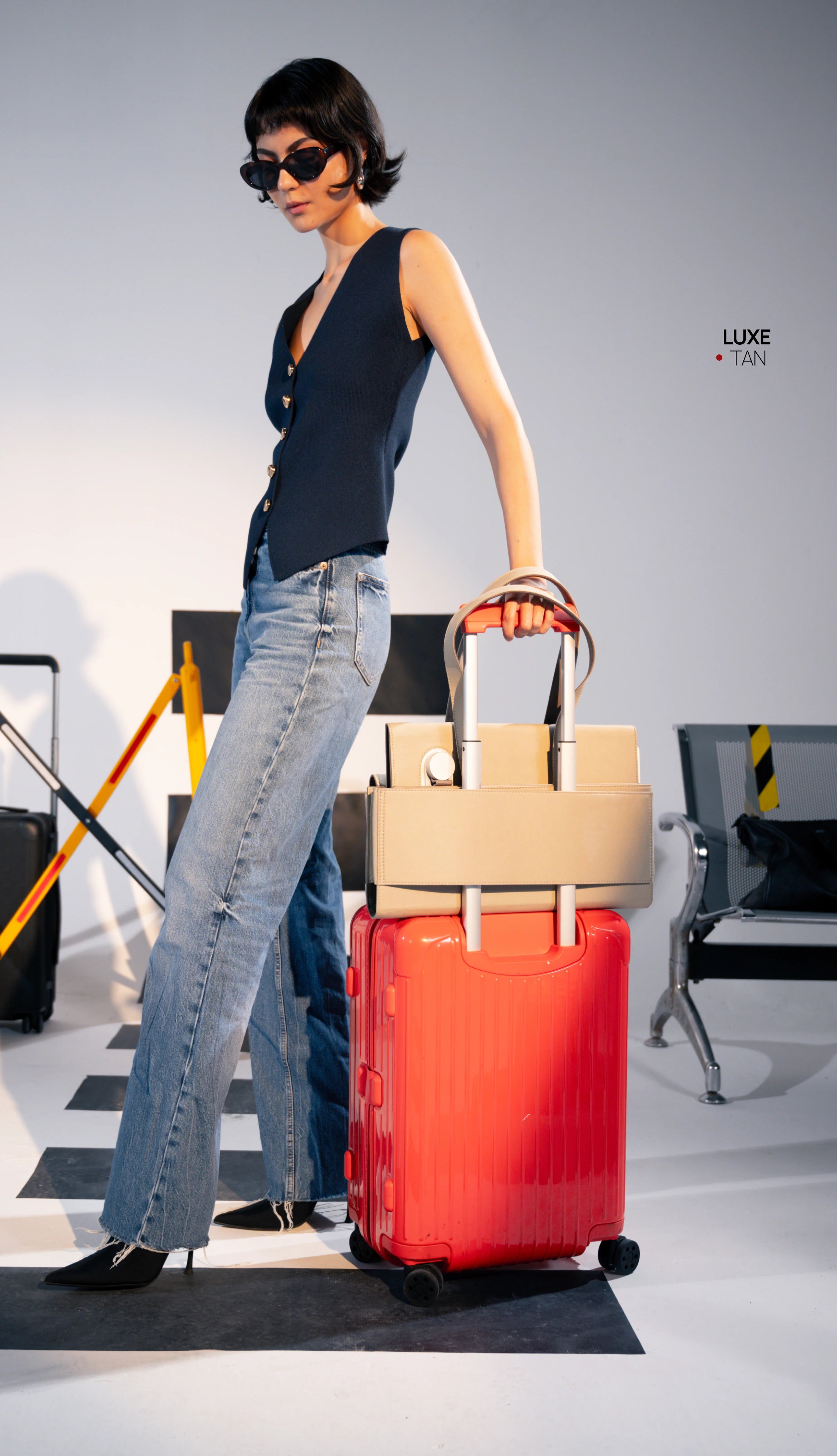 The charcoal tote on a suitcase
