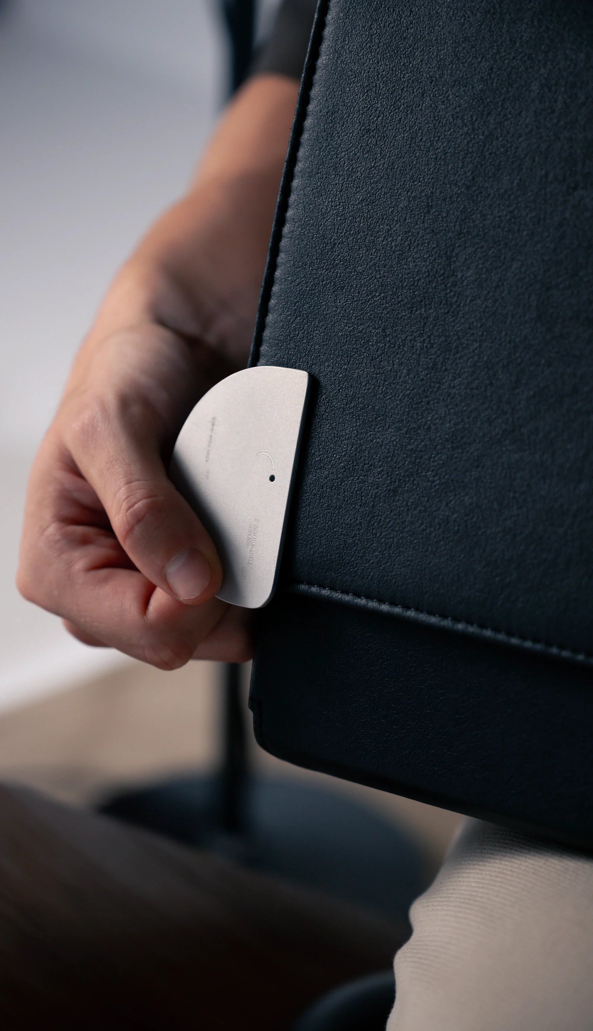 black leather laptop sleeve with sleek metal clasp and precision stitching