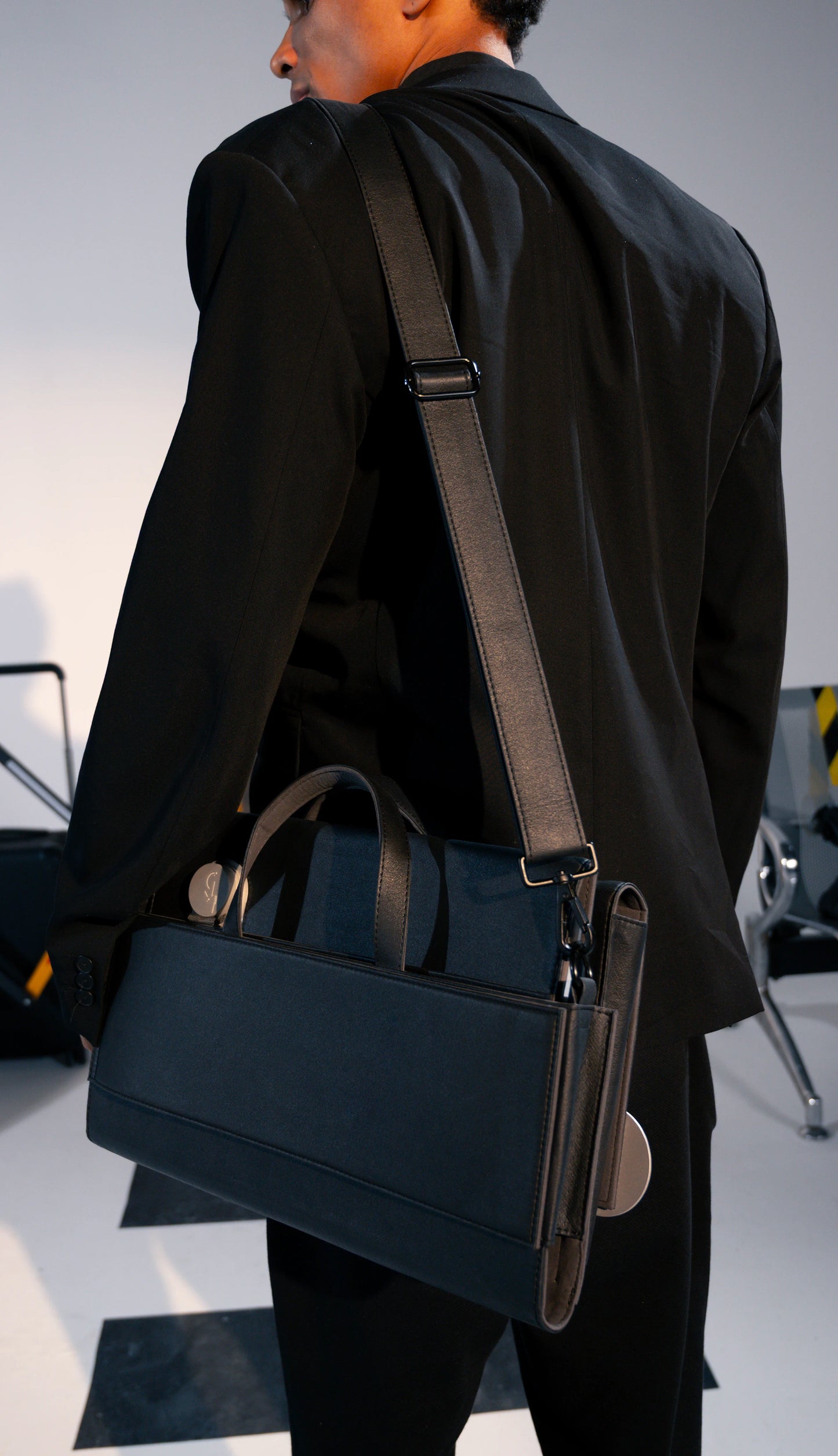 Person carrying a black office brief 