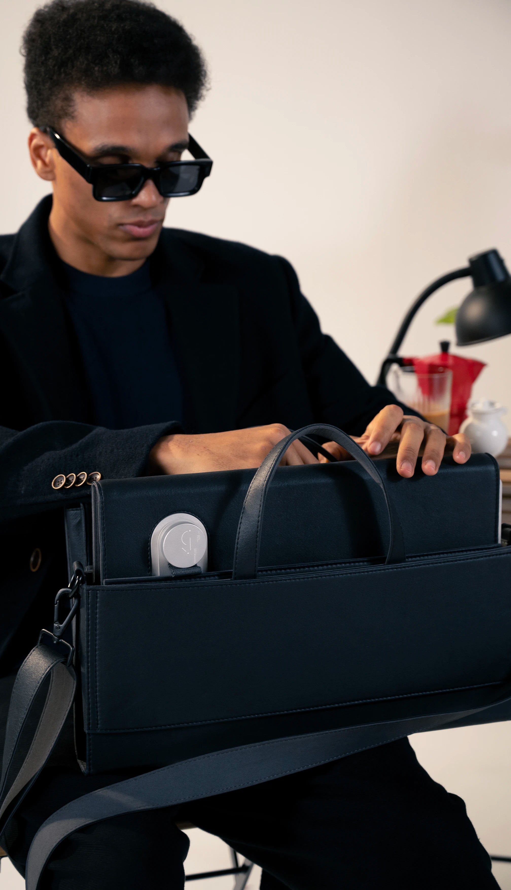 Sleek black briefcase with smart details, styled for modern professionals.